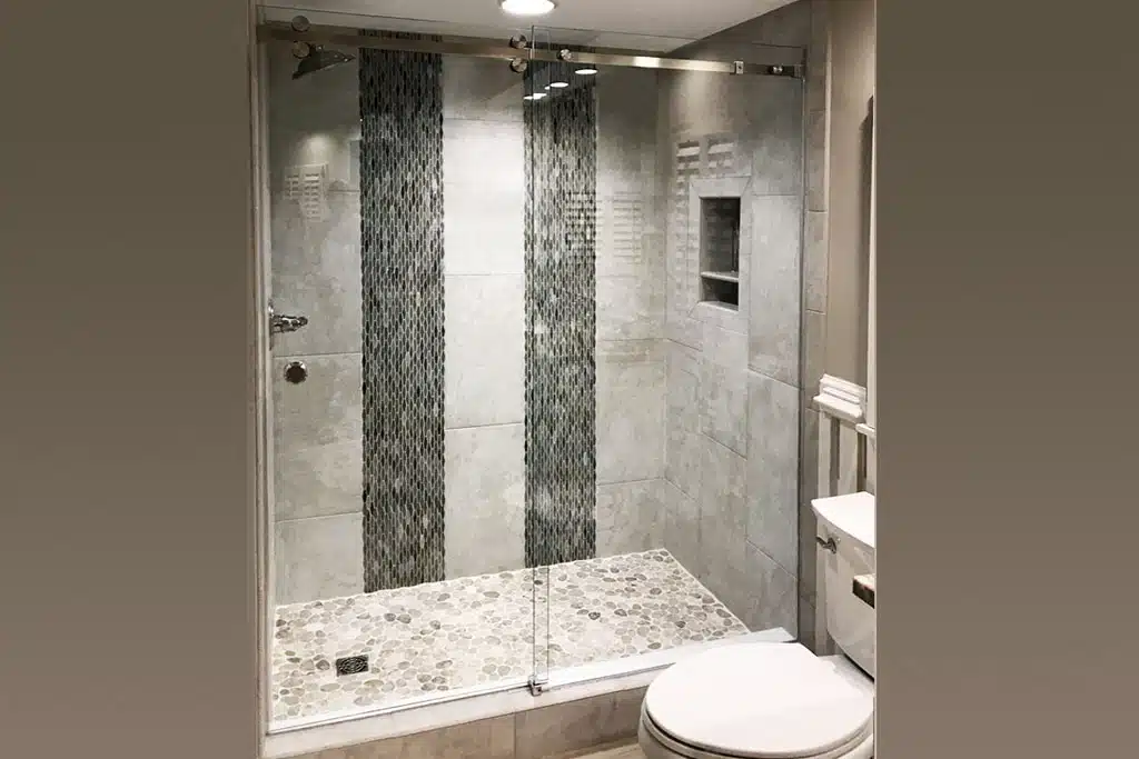 new glass shower doors inside a residential home masterbath | Glass company as a leading provider of all glass solutions in Alabama, Florida, Louisiana, Mississippi and South Carolina. Whether you are looking for a commercial storefront, windows, doors, showers, mirrors, patio screen rooms, or hurricane shutters, we can help you and deliver outstanding results.